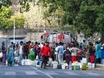 Residents of Vivekanand Camp in Delhi's Chanakyapuri fill empty vessels from a water tank on a hot summer afternoon on May 26.