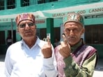Two elderly voters show their inked fingers during the Kullu panchayati raj elections on Tuesday. (Aqil Khan /HT)