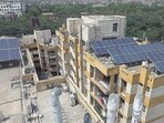 Under the scheme, the housing societies, high-rise buildings, government and semi-government institutions, aided institutions, commercial complexes and other premises spread over 5,000 square metres or more are required to install solar power plants. (HT Archive/representational image)