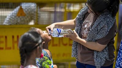 A lady offers water to a child amid scorching heat in New Delhi. (Raj K Raj/HT Photo) A lady offers water to a child amid scorching heat in New Delhi. (Raj K Raj/HT Photo)