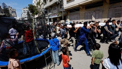People carry bodies identified by mourners as Hamas' military wing commander Mohammad Odeh, who was killed in an Israeli strike on Tuesday, and his wife and children, during a funeral, in Gaza City, May 27, 2026 (REUTERS) People carry bodies identified by mourners as Hamas' military wing commander Mohammad Odeh, who was killed in an Israeli strike on Tuesday, and his wife and children, during a funeral, in Gaza City, May 27, 2026 (REUTERS)