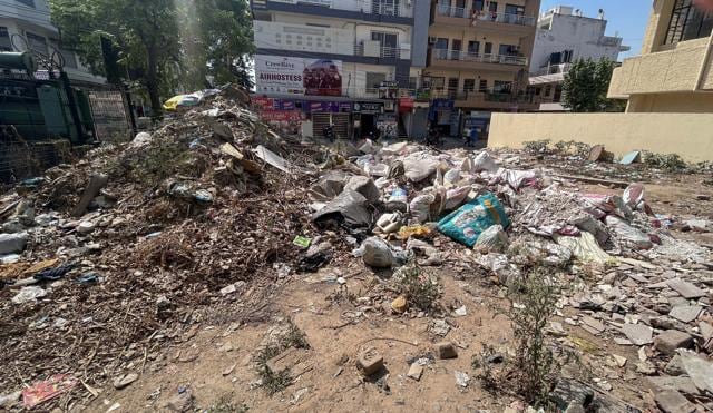 Illegally dumped waste in an empty plot in Sector 14 near Institutional area on Tuesday. (Parveen Kumar/HT)