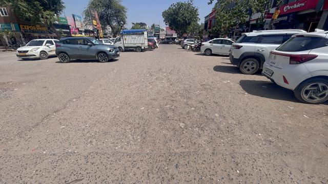 The eroded road of Sector-14 Market near the Mother Dairy booth, as seen on Tuesday. (Parveen Kumar/HT)