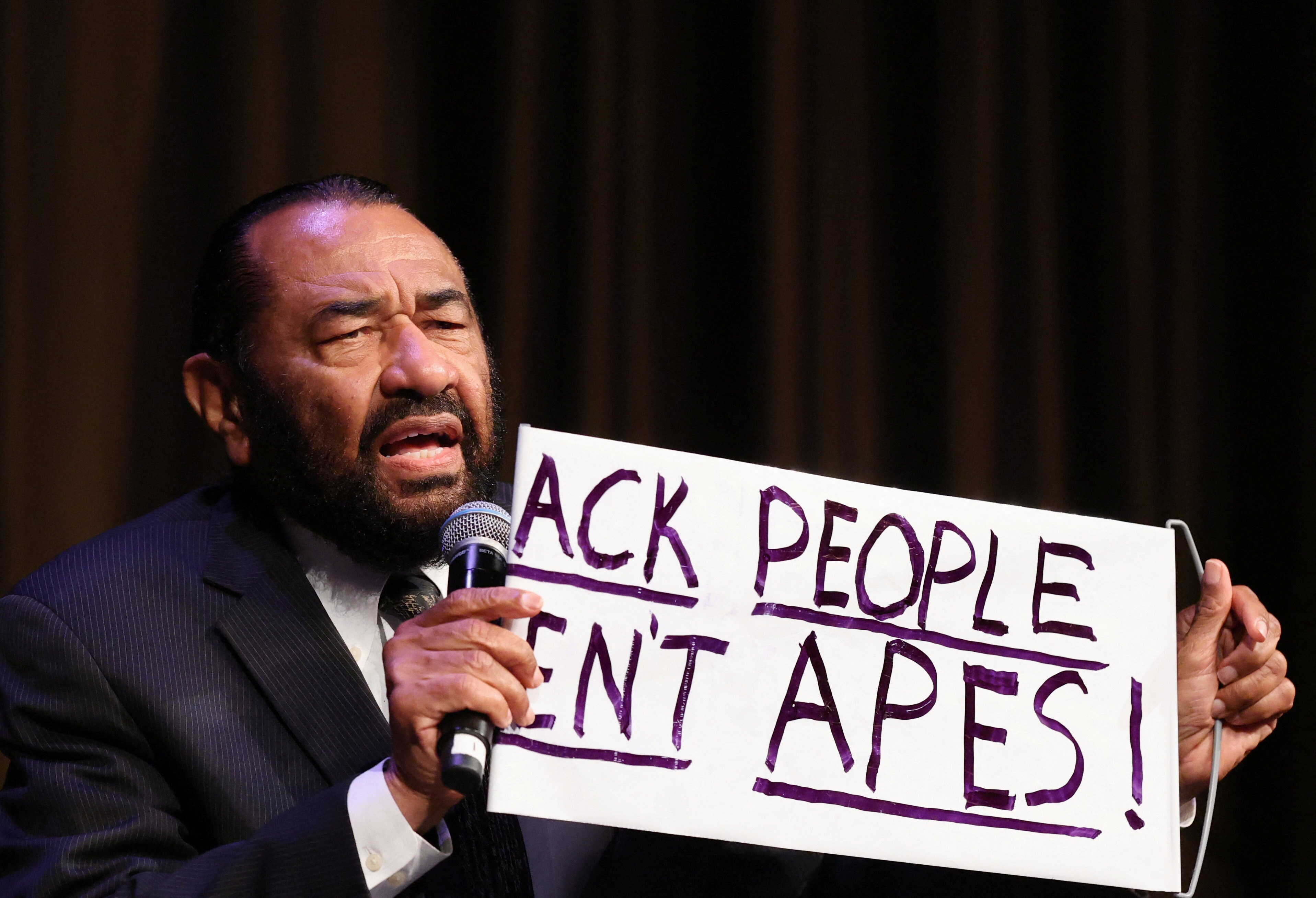 Al Green holds the sign reading "Black people aren't apes", which he brought to the State of the Union address on April 8. (REUTERS)