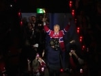 Former Montreal Canadiens player Claude Lemieux holds a torch as he enters the arena before Game 3 of the NHL Eastern Conference final