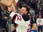 Former New Jersey Devils right wing Claude Lemieux holds the Conn Smythe Trophy after his team defeated the Detroit Red Wings