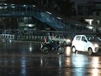 Commuters navigate through light rain at Rajiv Chowk near Mini Secretariat on Thursday. (Parveen Kumar/HT PHOTO)