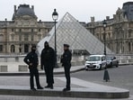 French police officers stand in front of the Louvre Museum after robbery, in Paris on October 19, 2025.