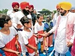 Punjab chief minister Bhagwant Mann shakes hands with young hockey players at Sant Avtar Singh Memorial Hockey Stadium in Jalandhar on Thursday. (@BhagwantMann X)