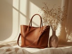 Chic office tote bags with smart bottle compartments and roomy interiors made for long workdays, meetings, commutes and coffee runs. (canva.com)