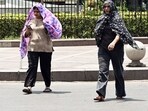 Women cover themselves with scarf to beat the heat, in New Delhi on Thursday. Women cover themselves with scarf to beat the heat, in New Delhi on Thursday.