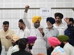 Aam Aadmi Party’s Ward No. 6 candidate Sunny Singh Ahluwalia (in yellow turban) at the counting centre in Phase 7,Mohali, on Friday. (Ravi Kumar/HT)