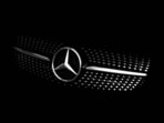 The Mercedes-Benz logo is pictured on the hood of a car.