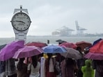 Kochi: Visitors at the Marine Drive on a rainy afternoon. Kochi: Visitors at the Marine Drive on a rainy afternoon.