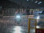 Commuters navigate through light rain at Rajiv Chowk near Mini Secretariat, Delhi Commuters navigate through light rain at Rajiv Chowk near Mini Secretariat, Delhi