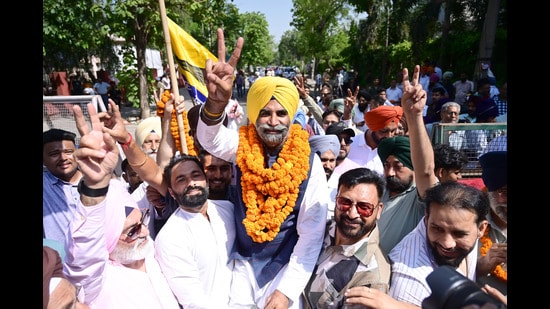AAP candidate Dr Sunny Ahluwalia celebrating with supporters after winning the municipal corporation at counting centre in Phase 7 Mohali on Friday. (Ravi Kumar/HT)