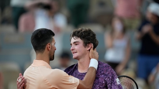Novak Djokovic of Serbia, left, and Joao Fonseca of Brazil hug after their third round men's singles tennis match at the French Open tennis tournament in Paris. (AP Photo/Christophe Ena)