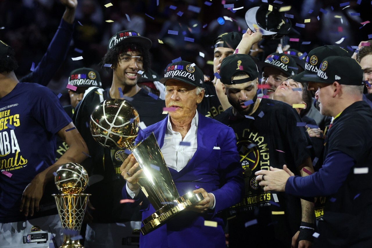 Denver Nuggets owner Stan Kroenke holds the Larry O'Brien Championship Trophy after winning the 2023 NBA Finals.