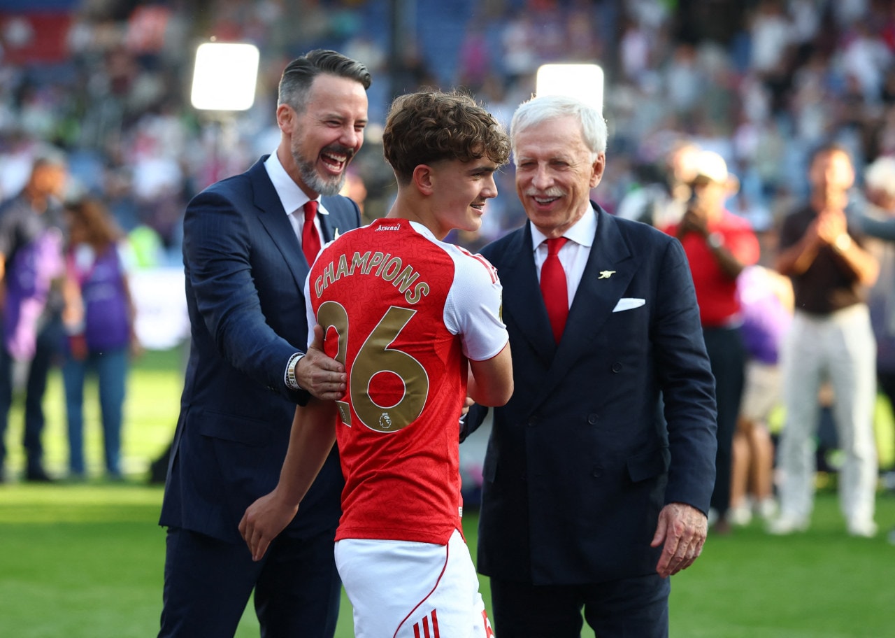 Arsenal's Max Dowman with owner Stan Kroenke, right, and son Josh Kroenke during the trophy ceremony.