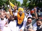 AAP candidate Dr Sunny Ahluwalia celebrating with supporters after winning the municipal corporation at counting centre in Phase 7 Mohali on Friday. (Ravi Kumar/HT)