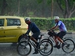 Cycling enthusiasts enjoying the rain in Chandigarh on Saturday morning. The weather took a turn for a pleasant after over 10 days of scorching heat. (Ravi Kumar/HT)