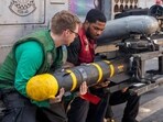 U.S. sailors, assigned to Helicopter Maritime Strike Squadron 46, unload an AGM-114 Hellfire missile from an MH-60R Sea Hawk helicopter during the Iran war at an undisclosed location, March 23, 2026. 