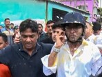 TMC General Secretary Abhishek Banerjee wears a helmet after stones, shoes and eggs were hurled at him during his visit to the families of post-poll violence victims, in Sonarpur, West Bengal, Saturday, May 30, 2026.