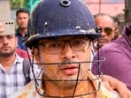 TMC General Secretary Abhishek Banerjee wears a helmet after stones, shoes and eggs were hurled at him during his visit to meet families of post-poll violence victims, in Sonarpur, West Bengal, Saturday, May 30, 2026.