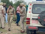 Police at the crime site near Chaheru village on the Jalandhar-Ludhiana National Highway on Saturday. (HT Photo)