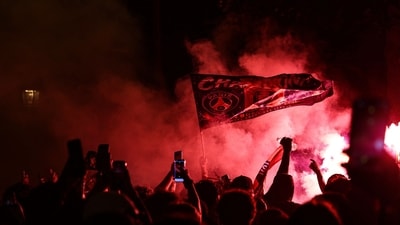 PSG supporters burn flares and wave a flag during gatherings. (Photo by ROMEO BOETZLE / AFP) (AFP) PSG supporters burn flares and wave a flag during gatherings. (Photo by ROMEO BOETZLE / AFP) (AFP)