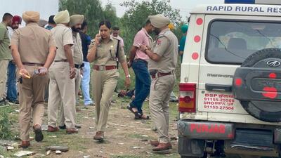 Police at the crime site near Chaheru village on the Jalandhar-Ludhiana National Highway on Saturday. (HT Photo)