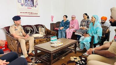 Punjab director general of police Gaurav Yadav with the family of ASI Joga Singh in Batala on Saturday. (HT)