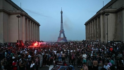 PSG supporters gather around a car that was set ablaze at Place du Trocadero opposite the Eiffel Tower in Paris on May 30, 2026. (Photo by LOU BENOIST / AFP) PSG supporters gather around a car that was set ablaze at Place du Trocadero opposite the Eiffel Tower in Paris on May 30, 2026. (Photo by LOU BENOIST / AFP)