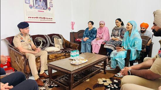 Punjab director general of police Gaurav Yadav with the family of ASI Joga Singh in Batala on Saturday. (HT)
