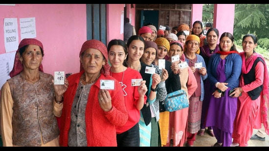 Voters showing their identity cards at a polling station in Mandi district on Saturday. (Birbal Sharma)