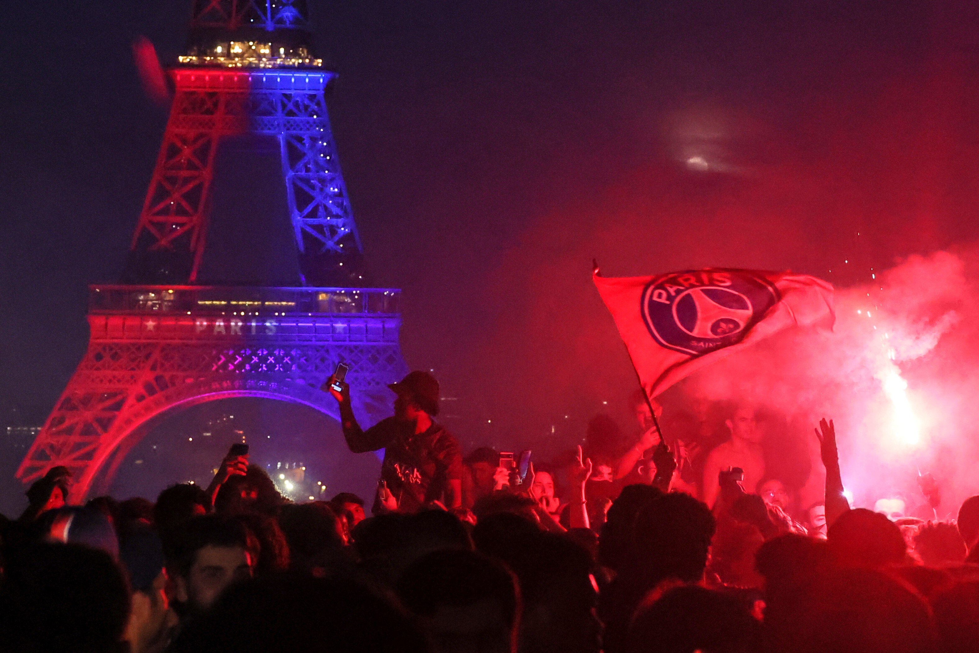 PSG supporters celebrate in Paris, Saturday, May 30, 2026 after the Champions League final soccer match between Paris Saint-Germain and Arsenal that's being played in Budapest, PSG won the match.. (AP Photo/Thomas Padilla)