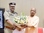 Chief minister Yogi Adityanath greets newly appointed Uttar Pradesh DGP Rajeev Krishna in Lucknow on Sunday. (HT Photo)