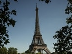 A tourist boat passes by the Eiffel Tower during a sunny day in Paris, Wednesday, May 27.