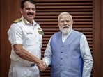 Prime Minister Narendra Modi, right, exchanges a handshake with outgoing Chief of the Naval Staff (CNS) Admiral Dinesh K Tripathi during a meeting.