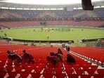 Support staff sweeps the stands ahead of the IPL final between RCB and GT in Ahmedabad on Sunday.