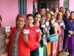Voters showing their identity cards at a polling station in Mandi district on Saturday. (Birbal Sharma)