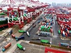 A cargo ship docked at a port with loaded containers. (AFP)
