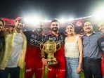 Royal Challengers Bengaluru's Virat Kohli, holding the trophy, poses for a picture with his wife, Anushka Sharma, and others after winning the Indian Premier League 2026 final 