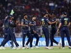 Gujarat Titans' Mohammed Siraj celebrates with teammates after taking the wicket of Royal Challengers Bengaluru's Venkatesh Iyer, caught by Kagiso Rabada