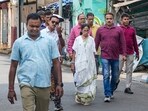 TMC supremo Mamata Banerjee walks towards the residence of party MP Kalyan Banerjee in Kolkata.