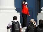 US President Donald Trump waves as he returns to the White House, in Washington, D.C.