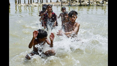 Children enjoy a refreshing dip in the Ganga to cool themselves off on a hot summer day, in Prayagraj on Monday. (ANI) Children enjoy a refreshing dip in the Ganga to cool themselves off on a hot summer day, in Prayagraj on Monday. (ANI)
