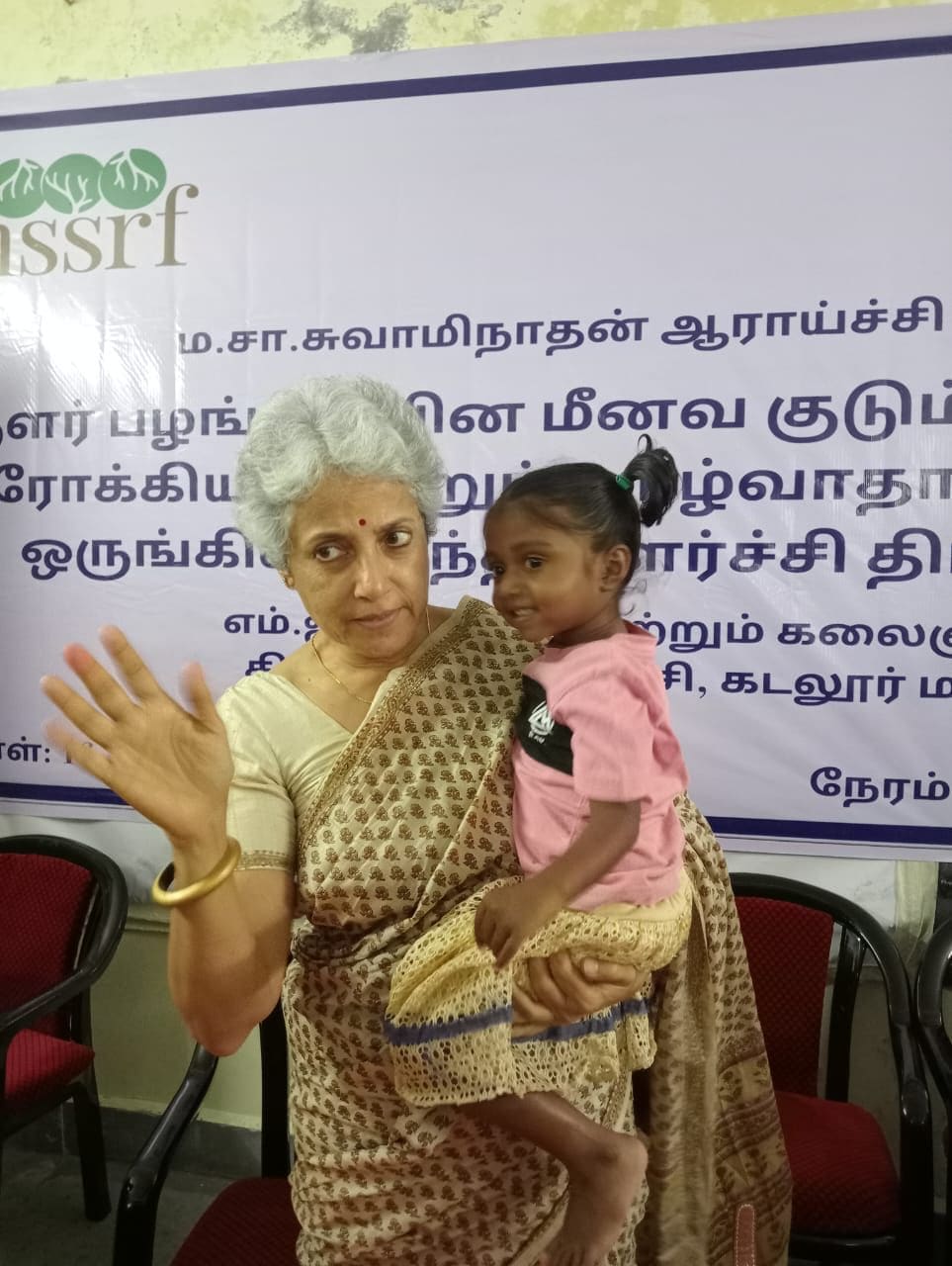 With the child of a fisherwoman in Cuddalore district, Tamil Nadu at a meeting to discuss occupational health issues. (Pic courtesy: Soumya Swaminathan)