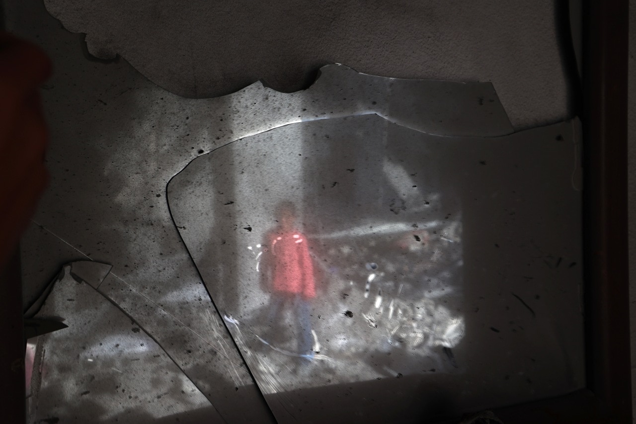 A Palestinian child standing amid rubble in central Gaza in May.