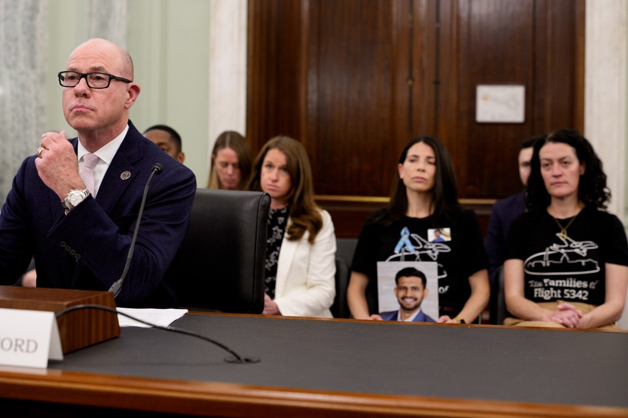 Family members of victims of the midair collision sit behind Bryan Bedford during a Senate committee hearing. Family members of victims of the midair collision sit behind Bryan Bedford during a Senate committee hearing.